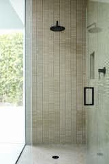 The shower is covered in Cottonwood mosaic and penny tiles by Ann Sacks. 