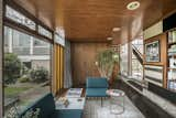 The original brick wall is made of a sand-lime mix; in front of it sits a sofa by Robin Day for Habitat. In the study, a Louis De Poortere rug, from a collection inspired by the 1960s, evokes Farnley Hey’s early years. The Yorkstone flooring has been well varnished over time. The seating unit is by Robin Day and the side table is by Oliver Bonas.