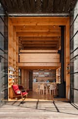 Double-height, steel-framed glass doors connect the entire home to its beachfront setting.