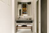 The bathroom and vanity area balance a sparse aesthetic with luxurious finishes.