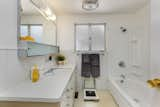 The original bathroom vanity is in excellent condition, with formica countertops and lots of storage. A built-in weight scale is another eccentric period feature of this home.