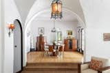 Groin vaults and barrel ceilings can be found all throughout the home, connecting one living space with another. Here, the living room steps up into the bright dining area.