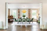 A look back at the dining room and its large windows overlooking the veranda. The large space seamlessly flows with the living room, but also offers pocket doors to divide the space as needed.