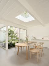 The dining area features a Roundish table from Maruni and Thonet 209 chairs.