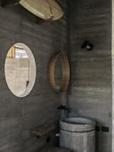 The bathroom picks up on the circular form of the home’s cylindrical stair and the “water mirror” on the roof.