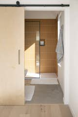 In total, the home offers three-and-a-half bathrooms. Each of the guest bathrooms are finished in the brightly colored tile.