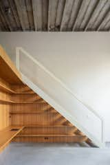 Built-in shelving under the stairs to the mezzanine level provides the resident with extra storage.