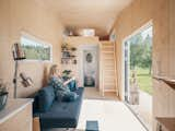 Oiled birch veneer lines the entire interior. Instead of the staircase, a ladder leads up to the loft where a skylight brings more light into the home. Situated on either side of the bathroom entry, closets make up for the storage lost by removing the stair.