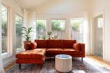 Where the screened porch once stood, the sunroom’s windows face the back yard on three sides. The sofa is from The Sofa Company, and the floor lamp is from CB2.