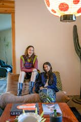 Kelly Kai (left) and Catalina Monsalve (right) relax in the Morongo Valley home they renovated together.