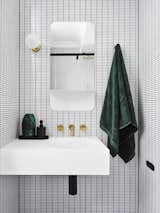 If designer Lynne Bradley had to choose a favorite bathroom design in her portfolio, it would be this guest bathroom. "Incorporating a strong, geometric pattern through the use ofwhite, rectangular mosaic tiles with black grout created the illusion of space," she says.