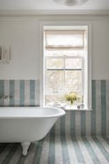 The team had a lot of discussions with the owner on the striped pattern of the Moroccan tile in the main bathroom, which makes the space feel larger and blends the green and cream palette used throughout the house.