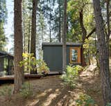 The shed, accessed via new exterior walkway, received new windows and new matte black corrugated metal roofing. The quaint accessory structure is now a guest sleeping space and flexible yoga room.