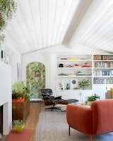 The renovated living room  gave the space a splash of white, icluding a fireplace makeover, but retained the original red oak floors.