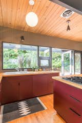 These custom laminate kitchen cabinets—built by local manufacturer Beech Tree Woodworks— add a pop of color to this Seattle kitchen.
