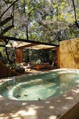 In Malinalco, Mexico, Casa Mague by <span style="font-family: Theinhardt, -apple-system, BlinkMacSystemFont, &quot;Segoe UI&quot;, Roboto, Oxygen-Sans, Ubuntu, Cantarell, &quot;Helvetica Neue&quot;, sans-serif;">Mauricio Ceballos X Architects </span><span style="font-family: Theinhardt, -apple-system, BlinkMacSystemFont, &quot;Segoe UI&quot;, Roboto, Oxygen-Sans, Ubuntu, Cantarell, &quot;Helvetica Neue&quot;, sans-serif;">draws inspiration from the region’s Aztec heritage. “Piramide de Malinalco, one of only three carved pyramids in the world, is part of the town’s daily life,” explains the firm’s director and founder, </span><span style="font-family: Theinhardt, -apple-system, BlinkMacSystemFont, &quot;Segoe UI&quot;, Roboto, Oxygen-Sans, Ubuntu, Cantarell, &quot;Helvetica Neue&quot;, sans-serif;">Mauricio Ceballos Pressler</span><span style="font-family: Theinhardt, -apple-system, BlinkMacSystemFont, &quot;Segoe UI&quot;, Roboto, Oxygen-Sans, Ubuntu, Cantarell, &quot;Helvetica Neue&quot;, sans-serif;">. “The inhabitants feel proud of their Aztec roots.” To honor them, and in direct reference to the nearby pyramid, an exterior living area adjacent to the pool in the first slide features a curved and stepped wood wall. To more broadly echo a Mesoamerican worldview, Pressler designed each room of the 2,906-square-foot home to feel as if it’s woven into the landscape. “Trees have ritual meaning,” he explains. “The roots symbolize the connection to the underworld, the trunks symbolize the earthly human life, and the branches symbolize the connection with the Gods.”</span>