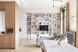 A wall of bookshelves with a library ladder enriches the sitting area.