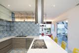 The bright colors and patterns are continued into the design of the kitchen.