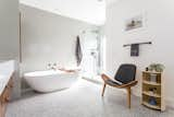 The bathroom floor is made of 24" square terrazzo tiles from Concrete Collaborative. The walls and shower floor feature Heath Ceramics field tiles.