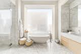 The two light-filled master bathrooms feature marble floors and walls.