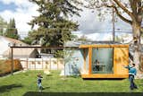 Portland, Oregon–based architects Heidi Beebe and Doug Skidmore designed a glass-walled studio to create a focal point in backyard of this Boise, Idaho house, and as a home office for one of the owners.