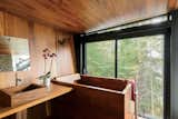 Architect Charlie Lazor designed this peaceful, lakeside prefab in Ontario, Canada, with a Japanese-style bathroom clad in richly stained teak with a matching tub and sink by Bath in Wood.