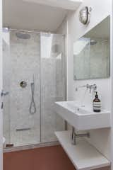 In the master bathroom, Forncae Briono tiles line the floor and walls.