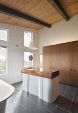 Because the eponymous grandparents don’t fuss over getting dressed up for a night on the town, a typical vanity with a mirror was not needed for the master bathroom. Dash Marshall designed the solid walnut vanity with built-in sink. It’s sealed with nautical varnish, with a base of bent steel sheetmetal powder coated in Pearlescent White.