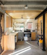 White paint brightens the modest kitchen of this Denver home. 