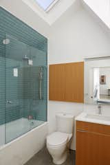 There is a half bath on the main level and this full one upstairs, which also has a skylight and generous ceiling height, thanks to the pitched roof. Douglas Fir cabinetry keeps consistent with the rest of the house.