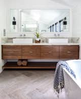 An engineered quartz counter tops a custom walnut vanity.