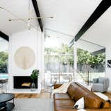 Revised landscaping at the back of the house enhances the indoor/outdoor feel of the home’s original architecture. The rug is from Target and the Mobile Chandelier is from West Elm.