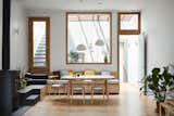 Tsai Design relocated the bedroom. In its place are the main living areas, including the dining room seen here. A built-in bench tucks neatly beneath the interior window. 