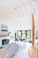 In the dining room, vintage Eames chairs surround the client’s table. The lighting overhead is the Helena Pendant from Kuzco. The Tadaima Console from Classicon sits against the wall.