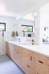 The wall opens up over the vanity so that there are views into the bedroom and backyard.