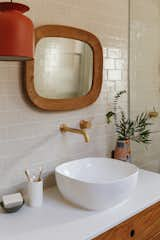 A rust-colored ceiling light syncs with the red accents elsewhere in the house.