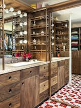 The sink has display shelves for the owner’s perfume bottle collection.