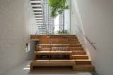 The stepped wooden platforms provide built-in seats for the library. Down the stairs to the left is a guest room.