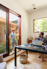 Large windows in the office help create the couple’s desired effect of permeability throughout the home.