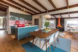 Blue-gray foil finish cabinetry contrasts pleasantly with a red penny tile backsplash. 