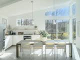 Now, the kitchen benefits from all the natural light brought in by the bump-out. The cabinets are Ikea's Sektion cainets with their base line Veddinge white lacquer finish fronts, topped with Ikea quartz counters. The hardware includes knobs from Lowe’s and pulls from Manzoni.