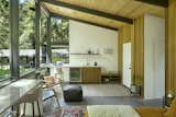 The one bedroom-one bath guesthouse has a kitchenette, and also utilizes the same materials as the main house: walnut cabinets, cedar walls, and the tongue and groove ceiling treatment.