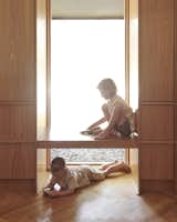 Berg floated a seating bench across a new kitchen window, which brings attention to the lowered sill placement.