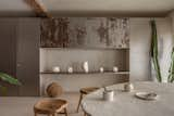 The cabinets and floating shelf are raw steel, and the handmade table is lime plaster, joined with Zara Home stools.