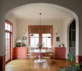 The couple added curved cabinetry and a window seat to form a breakfast nook, painted in Farrow &amp; Ball Red Earth. The table is discontinued from Anthropologie, where Kara previously worked as a display coordinator, and the overhead light is the Lambert &amp; Fils Waldorf Double.