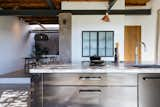 The custom steel kitchen island with a marble top is from Eginstill.