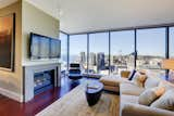 The living area showcases an amazing view of Puget Sound and downtown Seattle. Sectional from Patricia Edwards upholstered in AST fabric; cocktail table from Wendell Castle and the couples' original Eames Lounger.