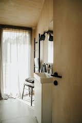 The home has a single bathroom with a tiled shower and small sink. There are some customization options when ordering a Manta North home, including the choice of black or grey light fixtures.