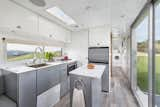 Taking design cues from boats, the founders of Living Vehicles used maintenance-free, weather-resistant aluminum for the interior walls and midcentury-style cabinetry. High-end appliances like a dishwasher and washer-drier combo are small and tucked away.