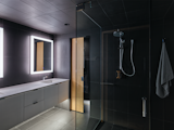 While most of the interior is clad in wood, the bathroom is covered in a sleek gray tile.